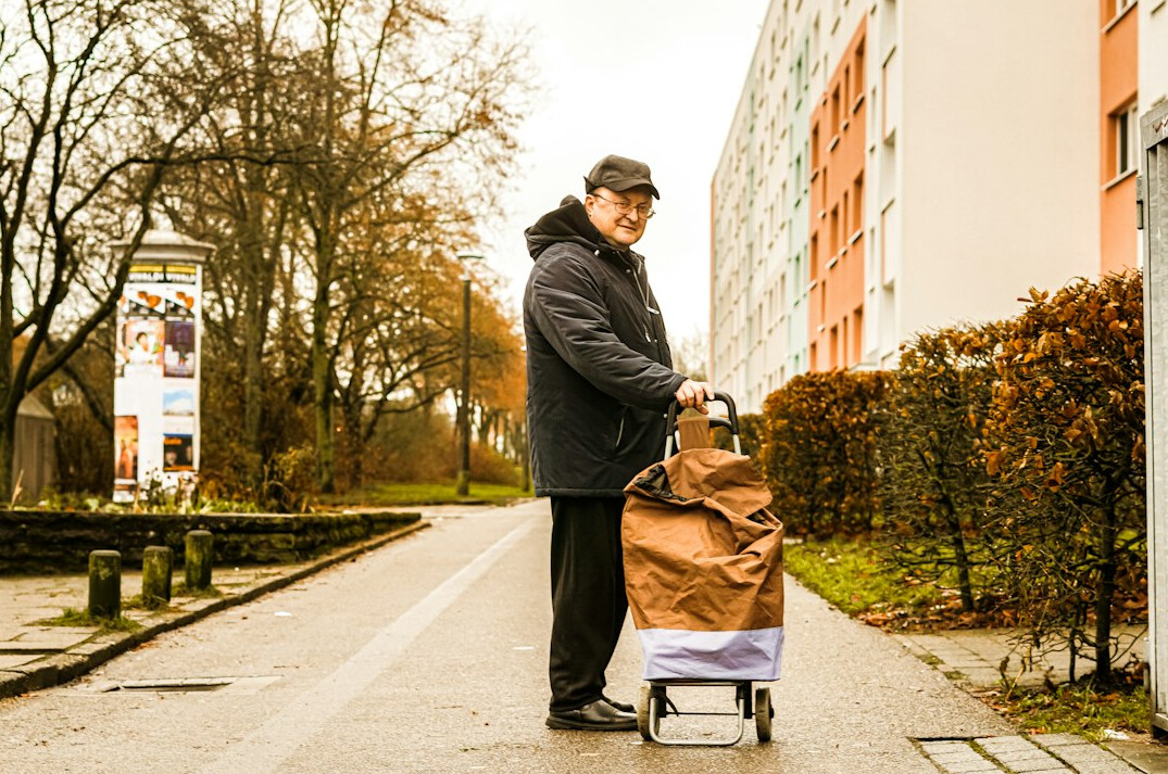 man pushing shopping cart