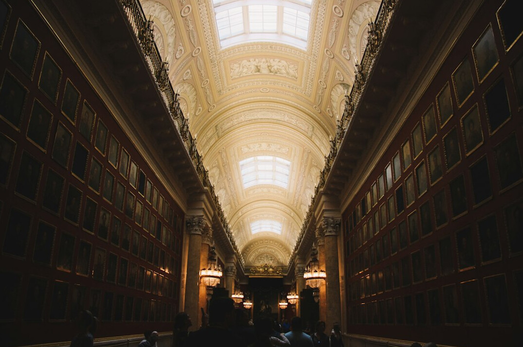 Old library with tall wooden bookshelves and warm light